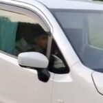 A small child is driving a car!